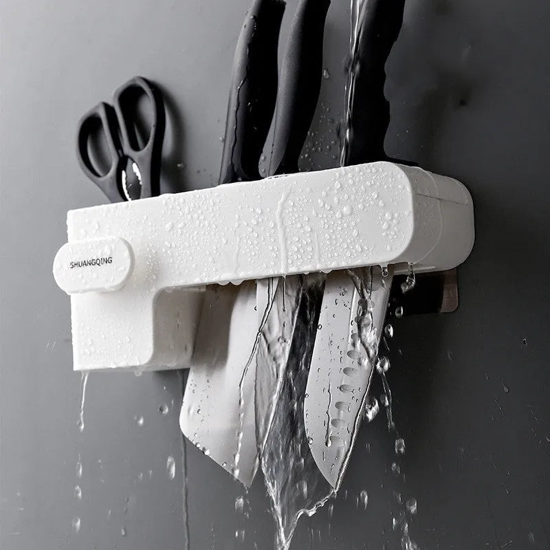 White plastic kitchen knife rack organiser with modern simple design on a countertop.