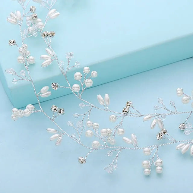 Handmade silver crystal and pearl long hair band for bridal hairstyles on a mannequin head.