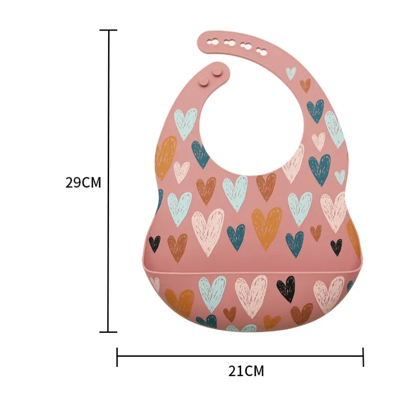 Silicone baby eating bib with adjustable neck and deep catch pocket on a child