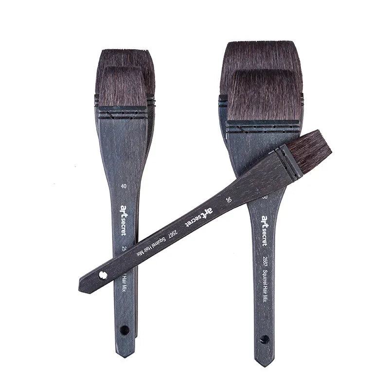 Grey squirrel hair makeup brush with a light wood handle on a plain background.