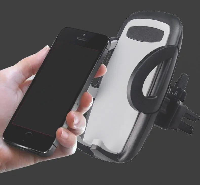 Black plastic mobile phone holder mounted on car air conditioning vent with phone in cradle