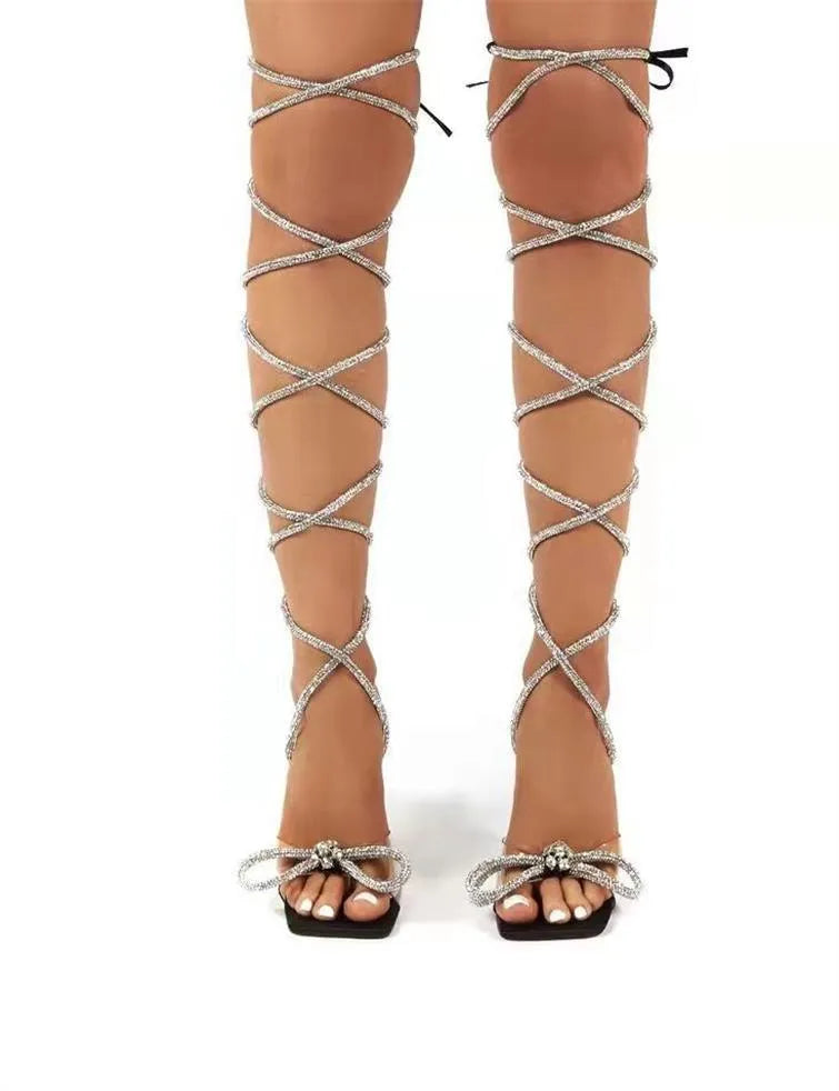 Plus size women's strappy high-heel sandals with rhinestone Roman straps and a square toe.