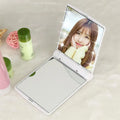 Folding LED pocket cosmetic mirror in Black, closed and open to show LEDs and compact size