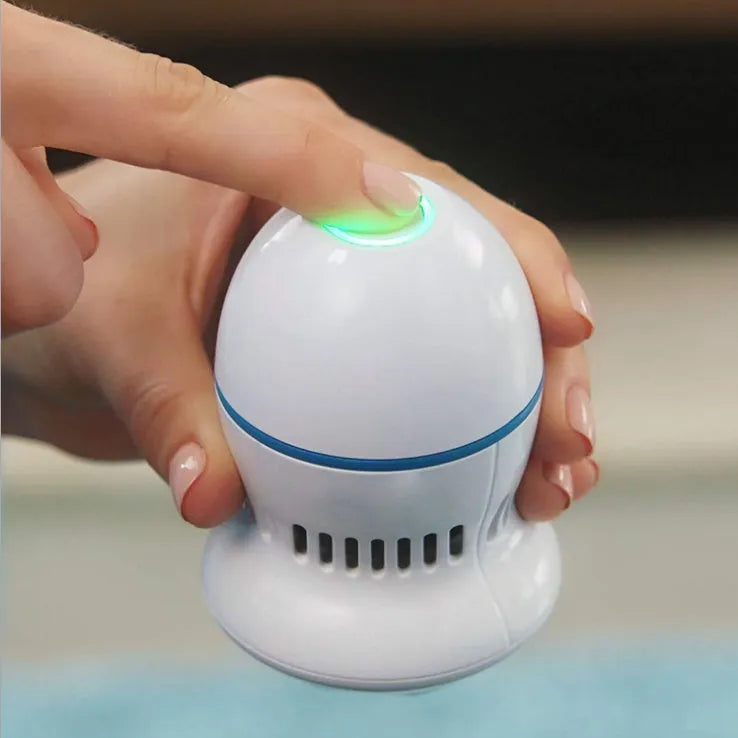 Beige and white electric foot file machine with grinding head, USB cable, two spare heads, brush, and sponge ring.
