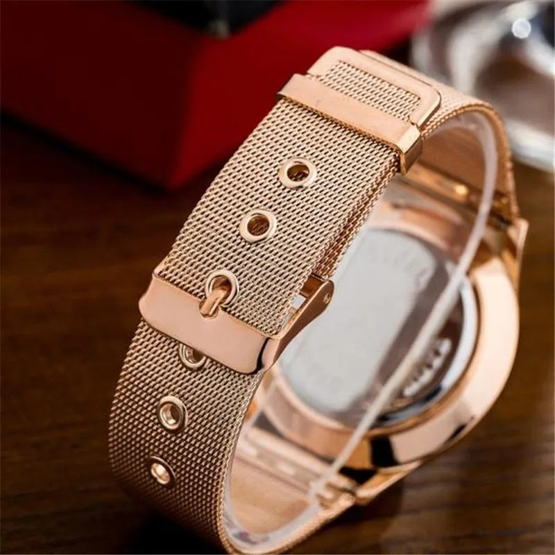 Unisex alloy mesh quartz watch with round silver case and dial on wrist