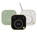 Black three-in-one wireless magnetic charger with desk lamp and USB cable on a wooden desk.