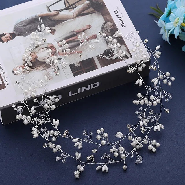 Handmade silver crystal and pearl long hair band for bridal hairstyles on a mannequin head.