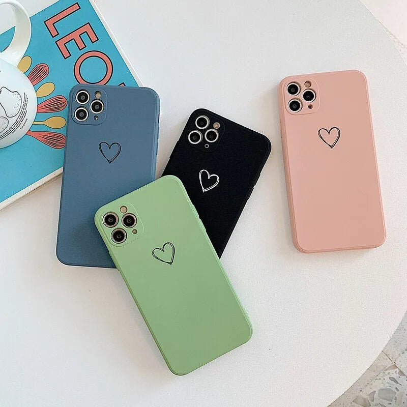 Silicone phone case for Apple iPhone in multiple solid colour options including black, pink, and purple