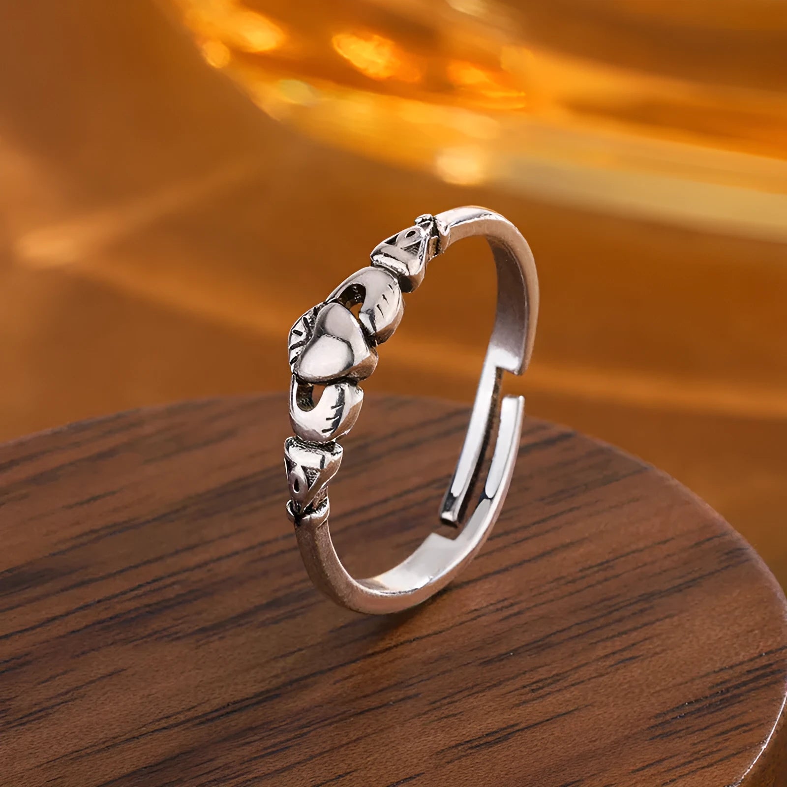 Retro silver heart open ring on finger showing adjustable copper construction and heart silhouette