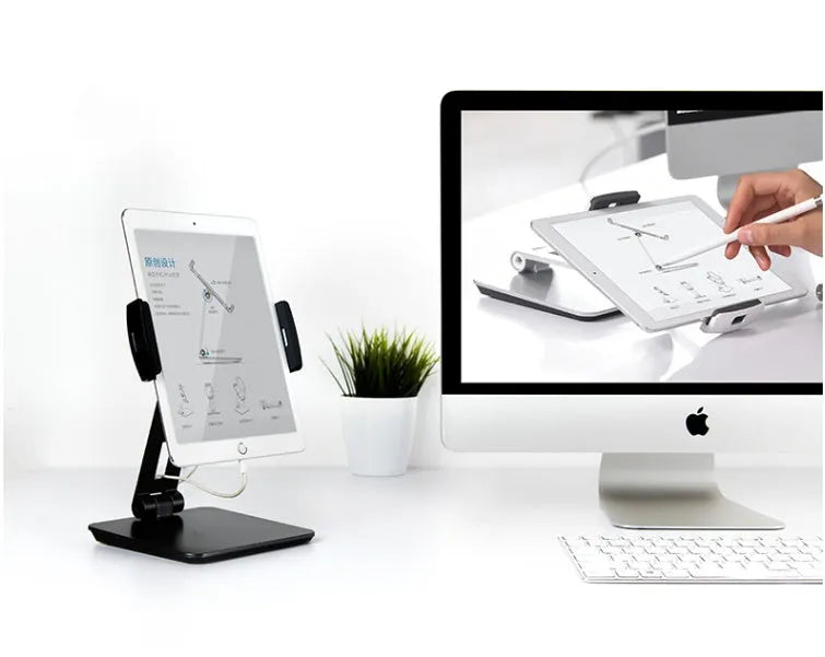 Folding aluminium phone and tablet stand with black silicone pads, shown holding a tablet at an angle.