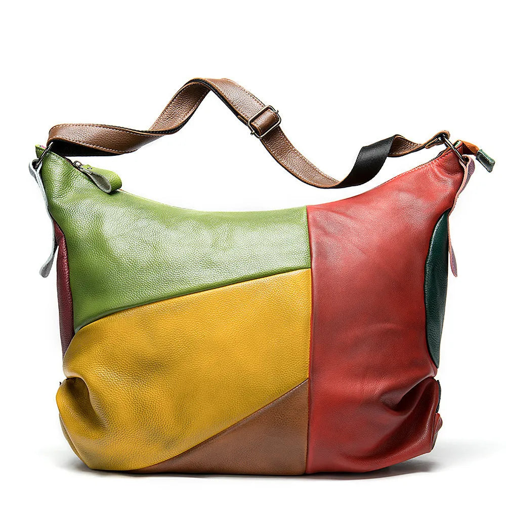 Brown cowhide leather crossbody travel bag with a laptop compartment, shown with adjustable strap.