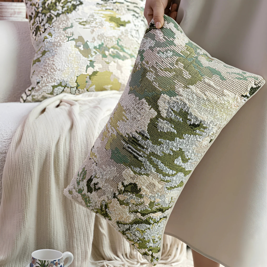Green wool blend cushion cover with a spring flowers botanical pattern, shown in square and lumbar sizes.