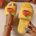 Halloween pumpkin plush slippers with synthetic fur uppers and PVC soles in white and yellow