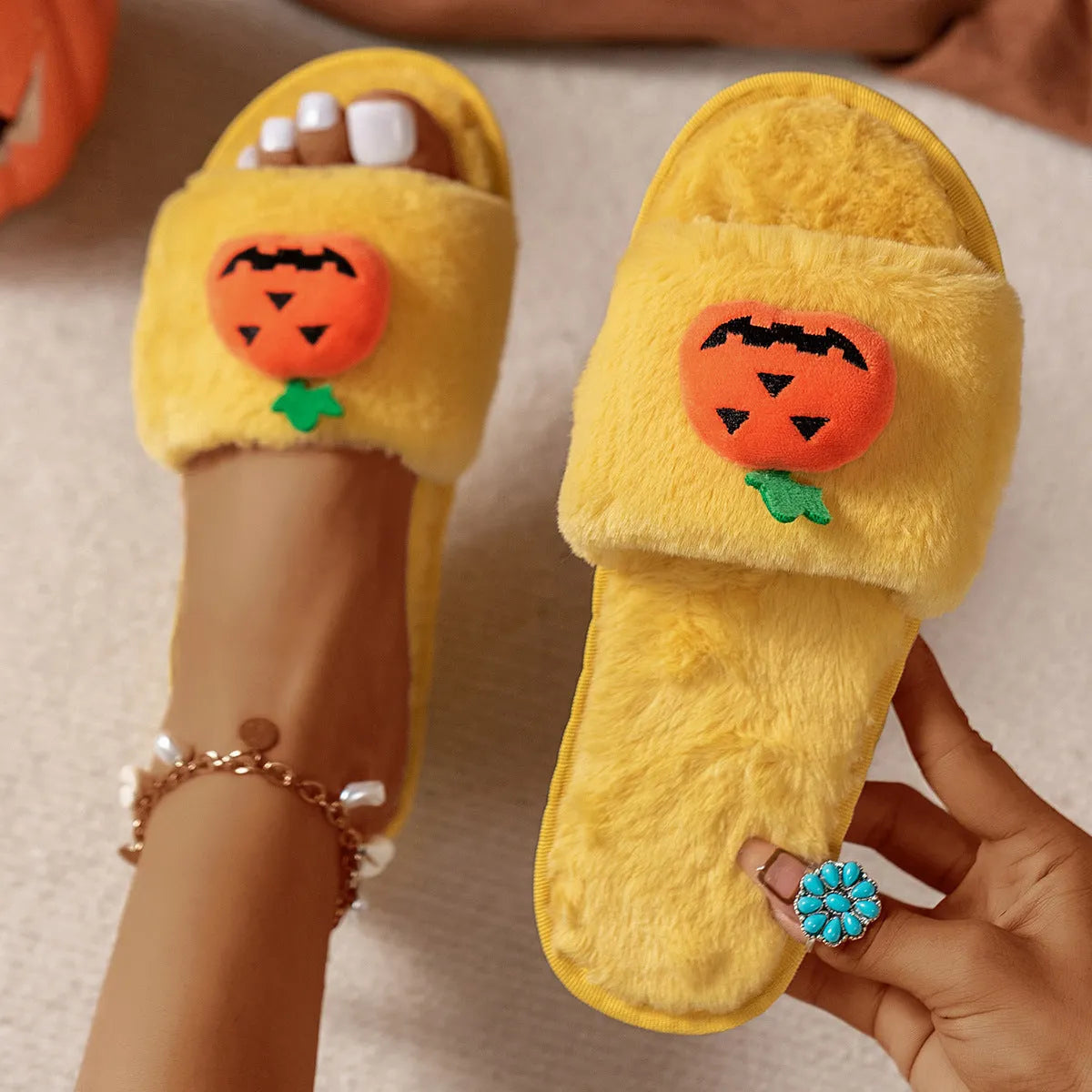 Halloween pumpkin plush slippers with synthetic fur uppers and PVC soles in white and yellow