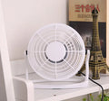 Mini adjustable USB desk fan in black, white, or blue on a workspace next to a laptop.