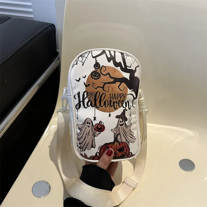 Women's black mini crossbody bag with orange Halloween pumpkin graffiti print.