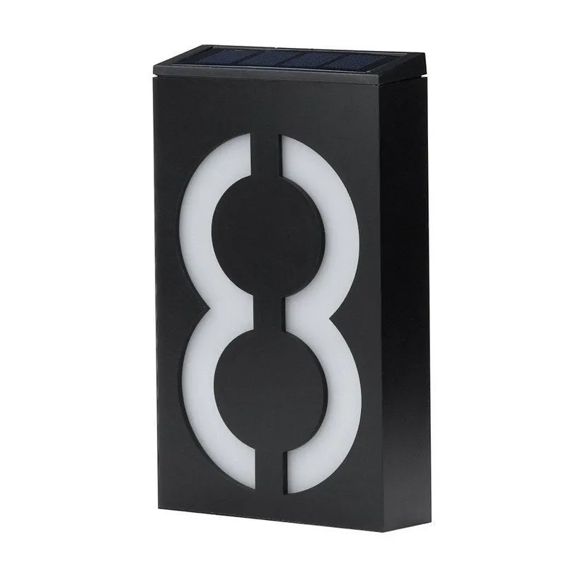 Solar powered LED illuminated house number plate with white digits, for outdoor wall mounting.