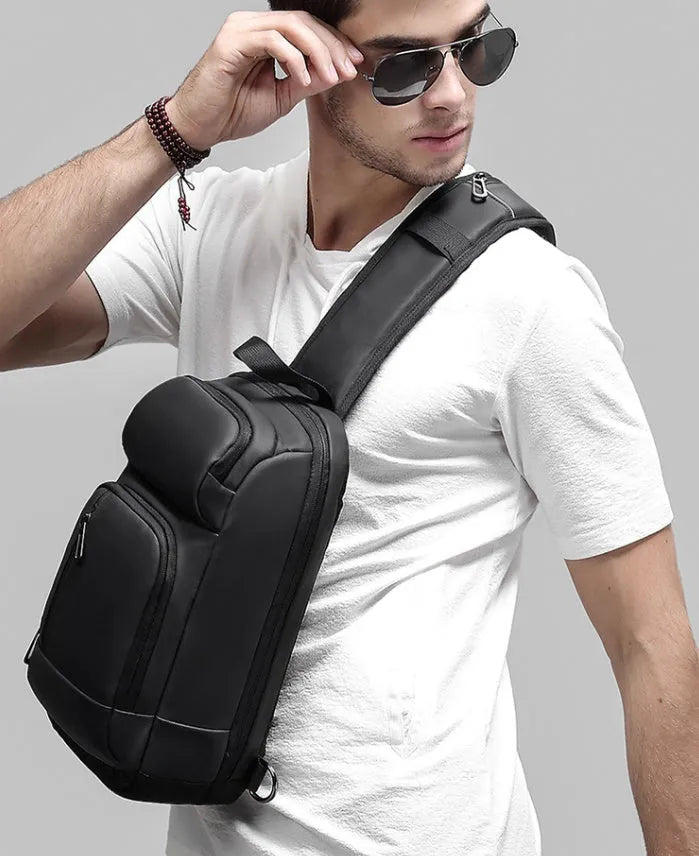 Black medium outdoor shoulder bag with square shape and air cushion strap
