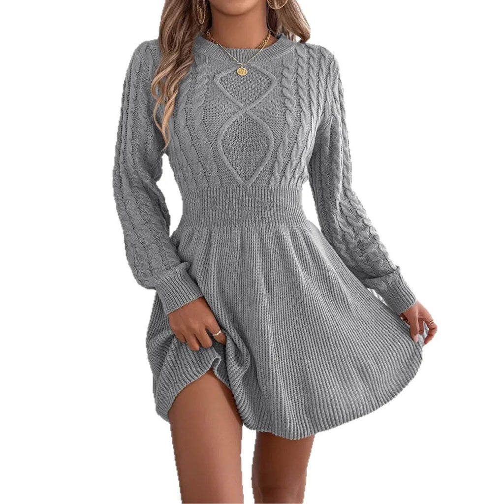 A solid colour sweater dress with lantern sleeves and an elastic waist, shown in black.