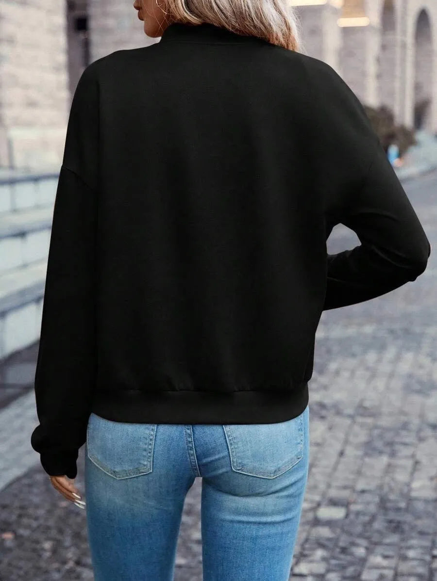 Women's solid black casual zip jacket with long sleeves, shown on a model.