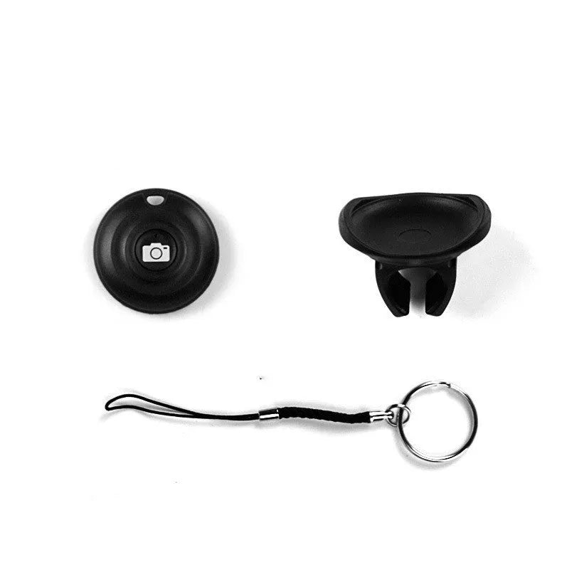 Black Bluetooth remote control for smartphone selfies and camera shutter.