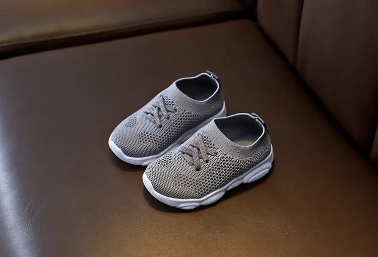 Children's fabric lazy shoes in white, black, pink, and grey colours with non-slip rubber sole