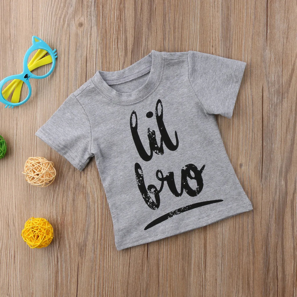Grey cotton children's t-shirt with printed sibling graphic, showing size range from 60cm to 140cm.