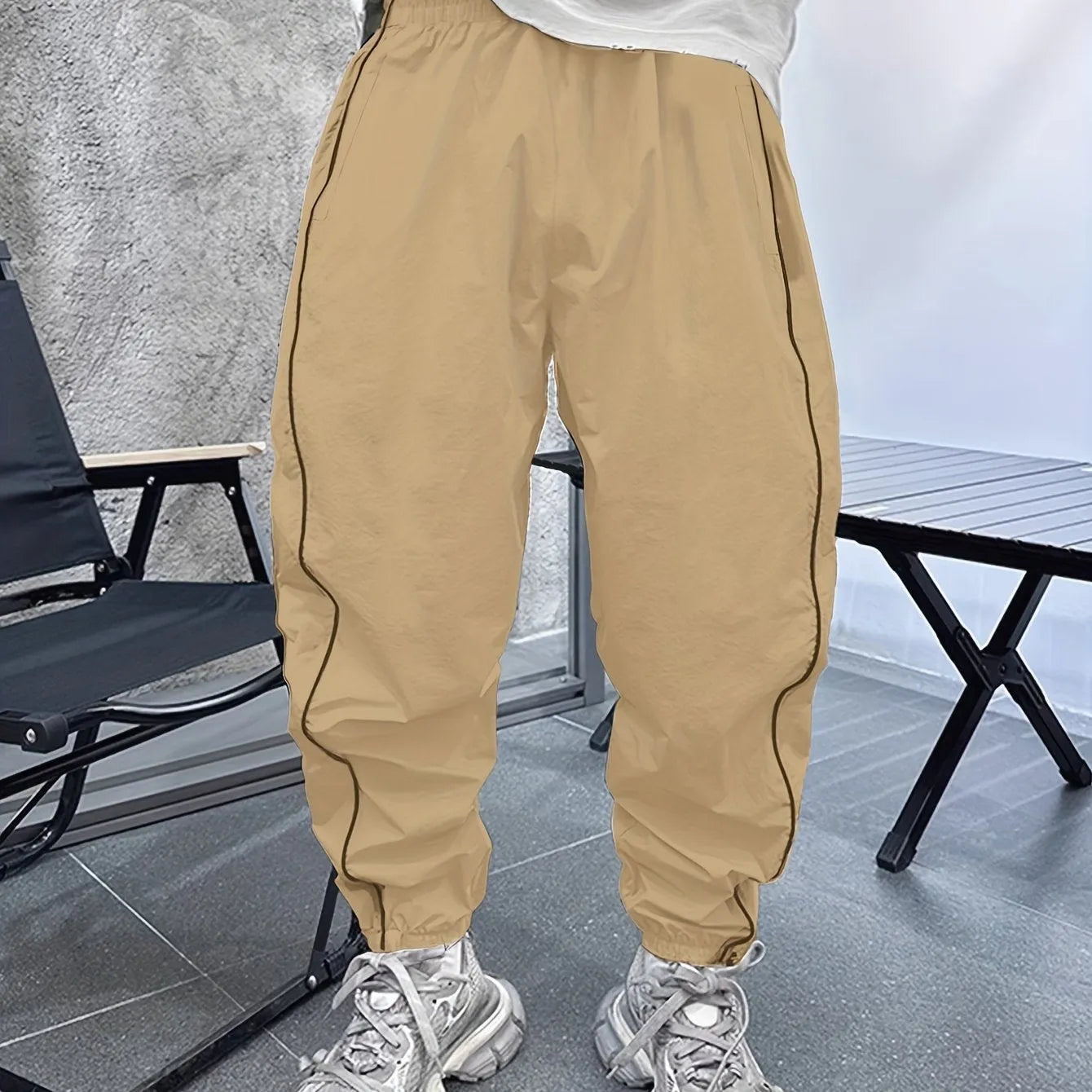 Man wearing loose, cropped blue bamboo fibre casual trousers.