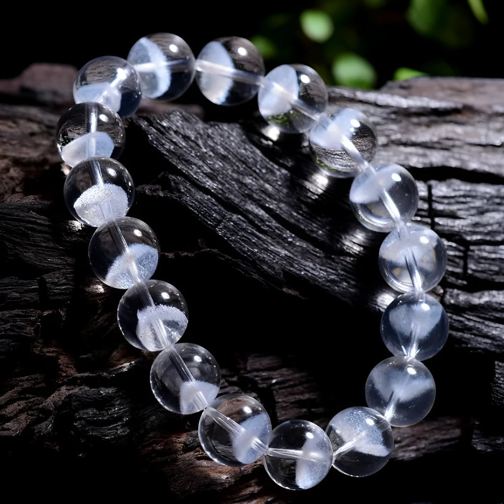 Women's white crystal pyramid bead ghost bracelet with a Ruyi charm on a white background.