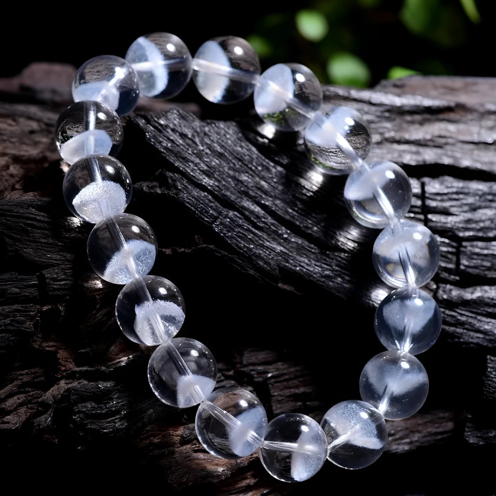 Women's white crystal pyramid bead ghost bracelet with a Ruyi charm on a white background.