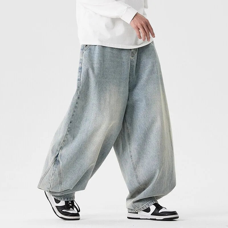 Man wearing light blue baggy fit denim jeans with a straight leg and low waist.