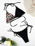 Women's red leopard print halter neck bikini with lace-up front on mannequin