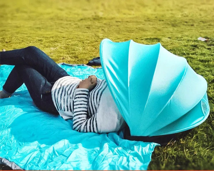Outdoor sunproof fold beach umbrella in blue with Lycra mesh shed and PVC pod on sand