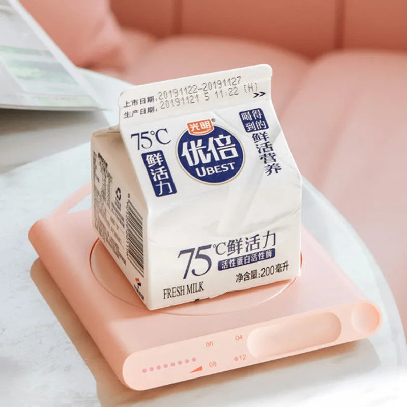 USB-powered heating cup pad in pink or white with mechanical controls