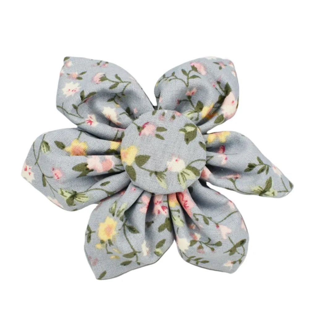 Blue floral patterned dog collar and matching leash, bow, vest, and poop bag set on a white background.