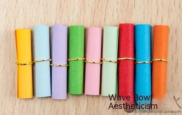 Assorted colourful mini paper scrolls with metal eyelets, shown in 3x7cm, 4x7cm and 5x5cm sizes