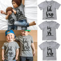 Grey cotton children's t-shirt with printed sibling graphic, showing size range from 60cm to 140cm.