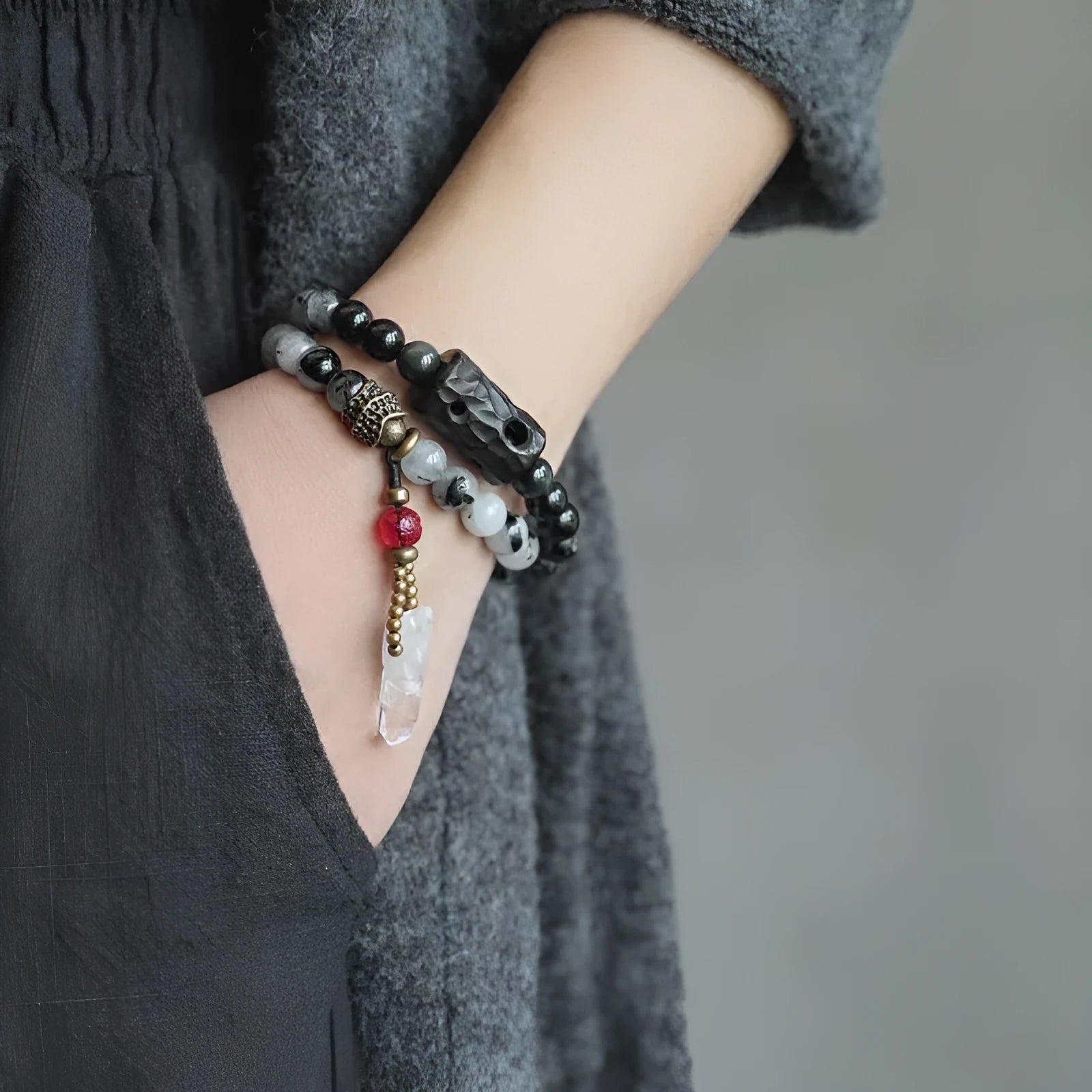 Ethnic black hair bracelet with white crystal tassel showing bending and lacing construction