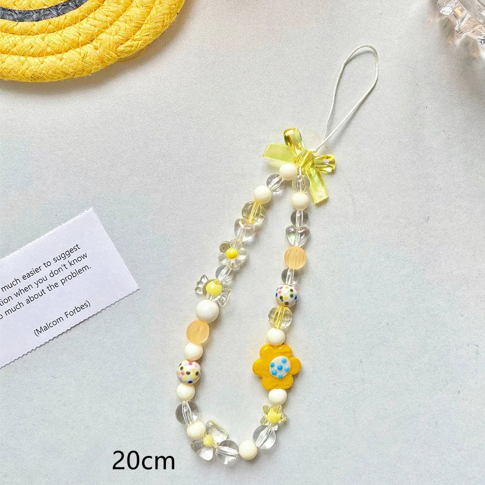 Blue, pink, and yellow beaded flower phone lanyard on a white background.