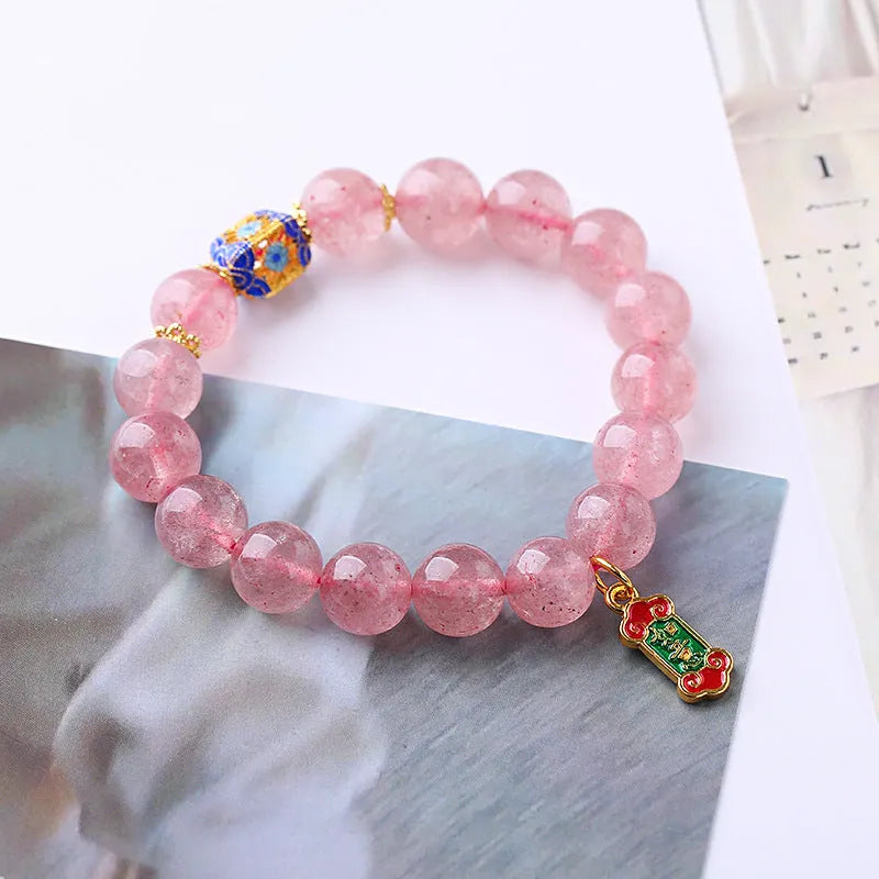 Pink crystal bracelet with hand-woven design featuring Ruyi charm and text elements