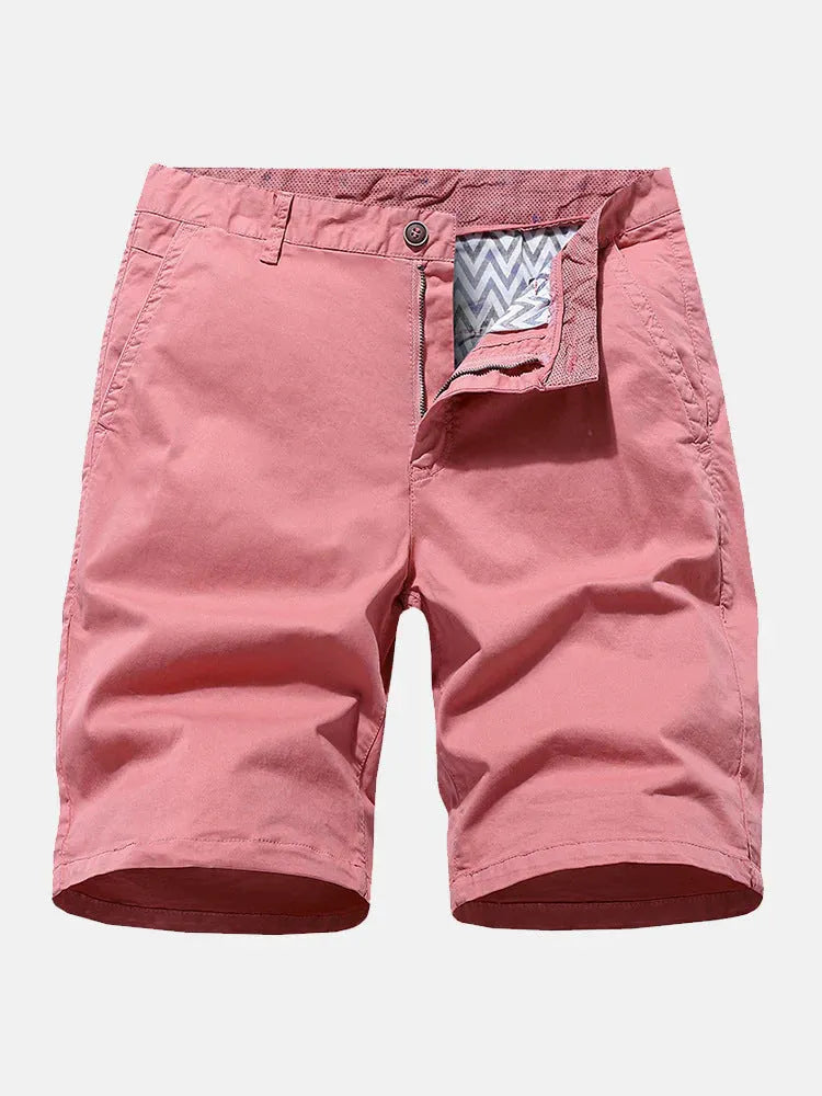 Men's loose-fit denim work shorts in blue, shown in a casual setting.