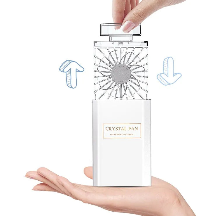 Pink portable rechargeable perfume fan with essential oil diffuser and USB charging port.