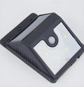 White solar-powered outdoor LED motion sensor light unit mounted on a wall.