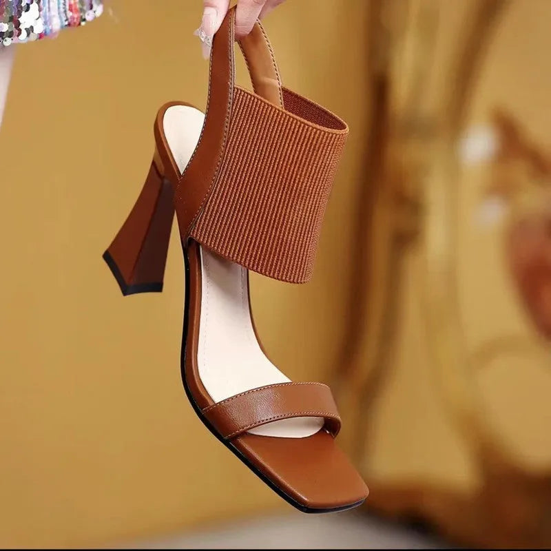 Women's black high heel sandals with elastic straps and rubber soles