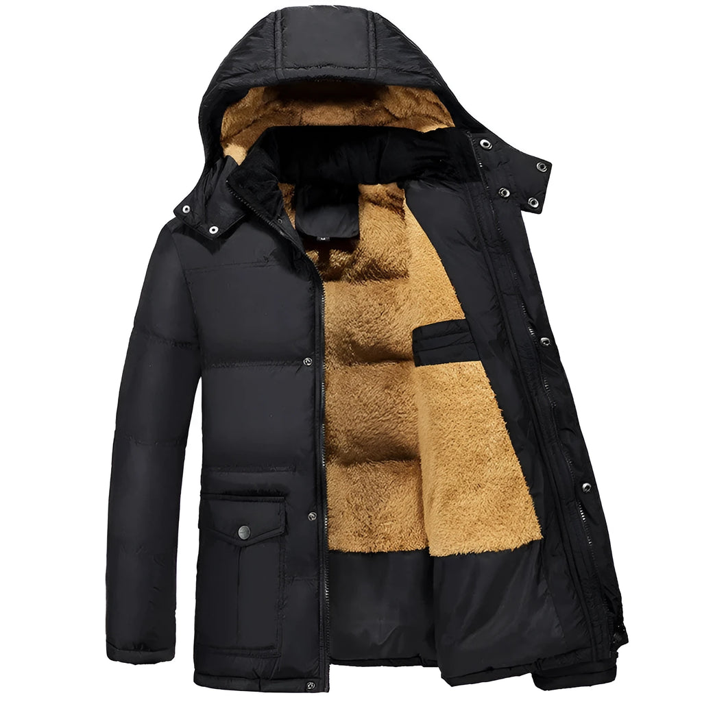 Man wearing a black loose fit double-breasted velvet padded jacket with a hood.