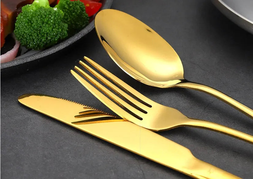 24 piece stainless steel tableware set showing knives, forks, and spoons in multiple colour finishes