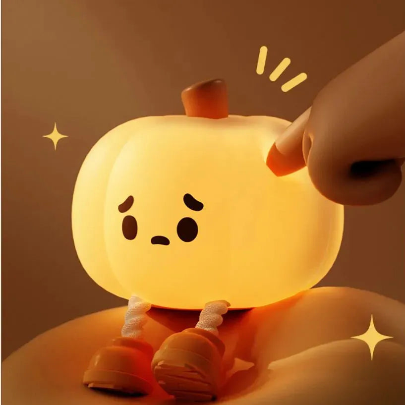 Soft silicone pumpkin-shaped night light with warm yellow glow