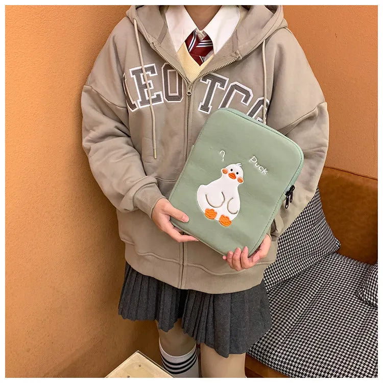 Blue cotton tablet case with embroidered cartoon duck design and a zip closure.