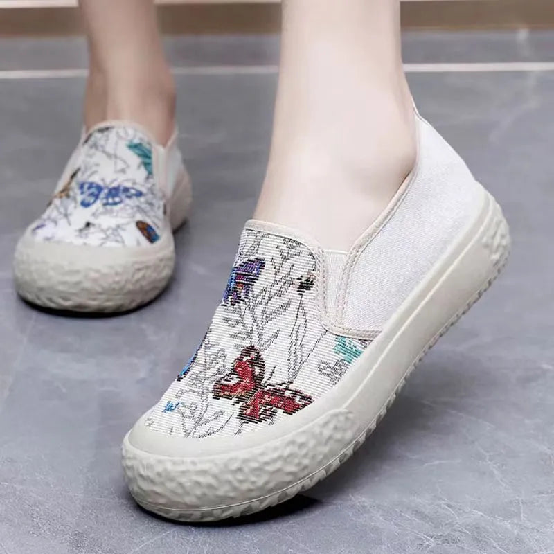 Old Beijing women's slip-on canvas shoes in black or white with a round toe and shallow cut.