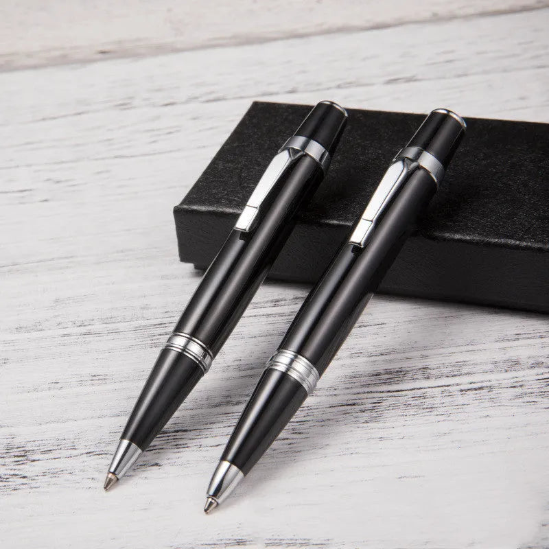 Short black metal ballpoint pen with rotating mechanism, showing bullet tip and compact dimensions